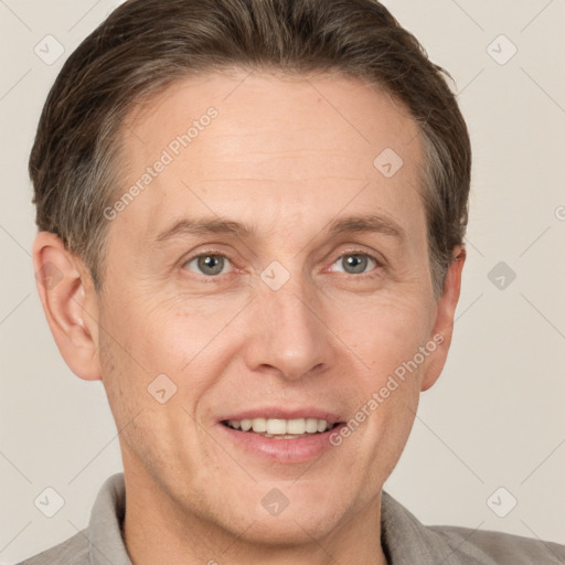 Joyful white adult male with short  brown hair and grey eyes