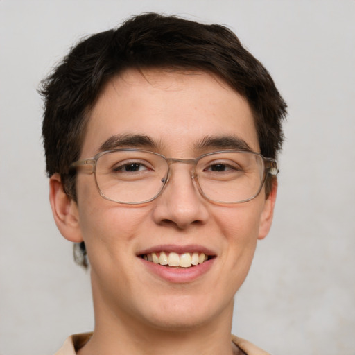 Joyful white young-adult male with short  brown hair and green eyes