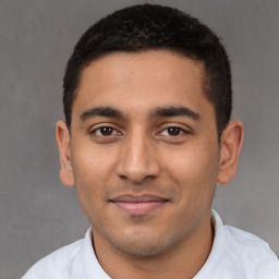 Joyful latino young-adult male with short  black hair and brown eyes