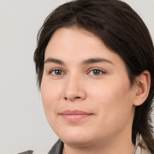 Joyful white young-adult female with medium  brown hair and brown eyes