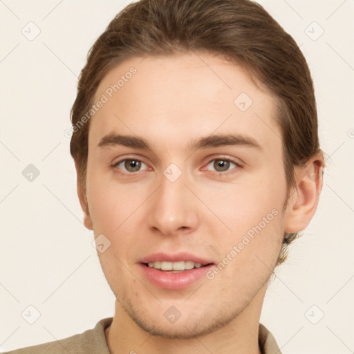 Joyful white young-adult male with short  brown hair and grey eyes