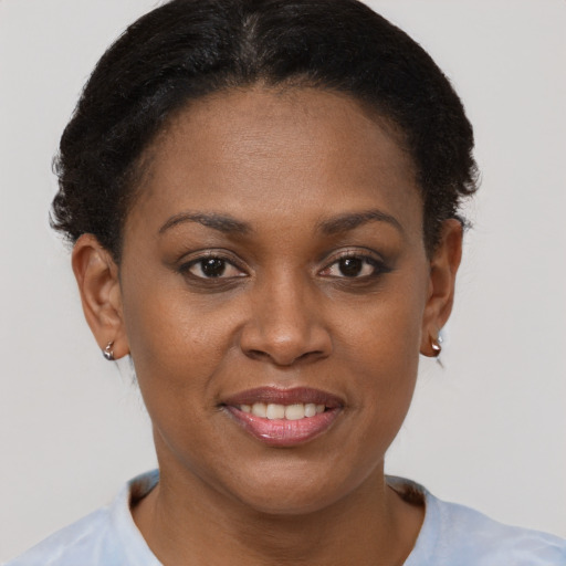 Joyful black young-adult female with short  brown hair and brown eyes