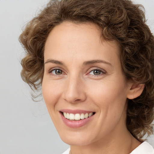 Joyful white young-adult female with medium  brown hair and green eyes