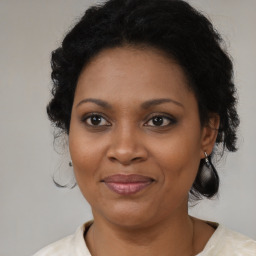 Joyful black adult female with medium  brown hair and brown eyes