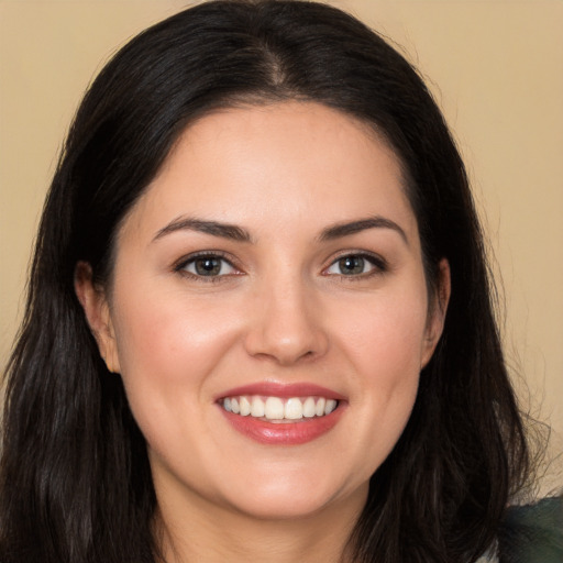 Joyful white young-adult female with long  brown hair and brown eyes