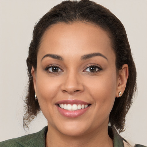 Joyful white young-adult female with medium  brown hair and brown eyes