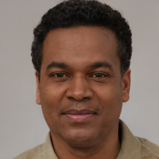 Joyful latino adult male with short  black hair and brown eyes