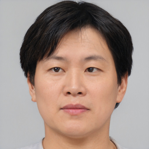 Neutral asian adult male with short  brown hair and brown eyes