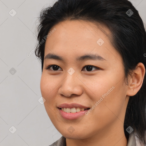 Joyful asian young-adult female with medium  brown hair and brown eyes