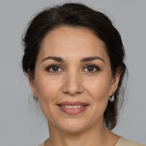 Joyful white adult female with medium  brown hair and brown eyes