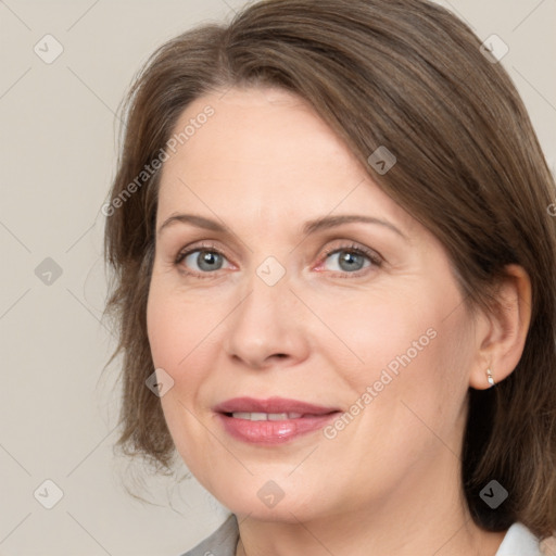 Joyful white adult female with medium  brown hair and grey eyes