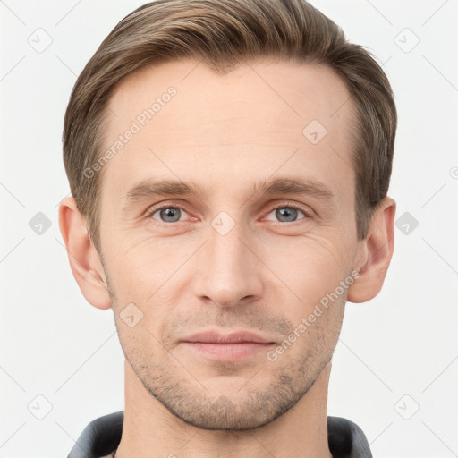 Joyful white young-adult male with short  brown hair and grey eyes