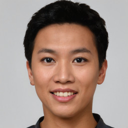 Joyful asian young-adult male with short  black hair and brown eyes