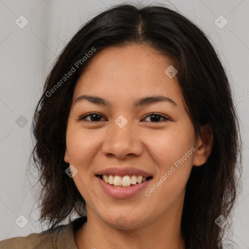 Joyful latino young-adult female with long  brown hair and brown eyes