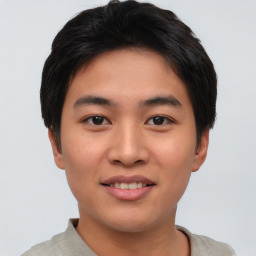 Joyful asian young-adult male with short  brown hair and brown eyes