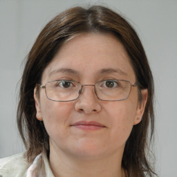 Joyful white adult female with medium  brown hair and brown eyes