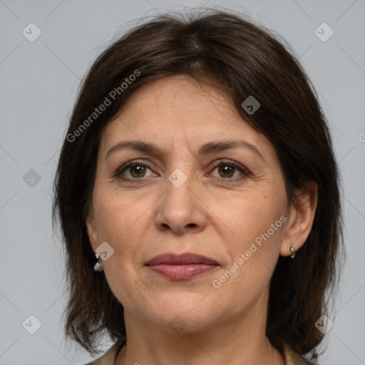 Joyful white adult female with medium  brown hair and brown eyes