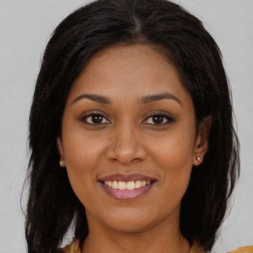 Joyful asian young-adult female with long  brown hair and brown eyes