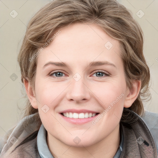 Joyful white young-adult female with medium  brown hair and blue eyes