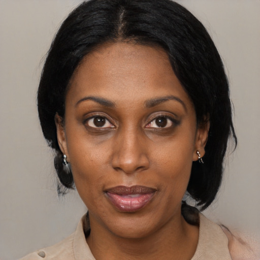 Joyful black adult female with medium  black hair and brown eyes
