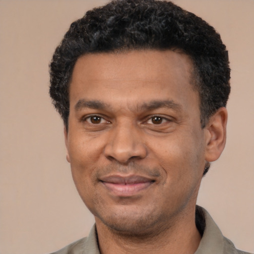 Joyful latino adult male with short  black hair and brown eyes