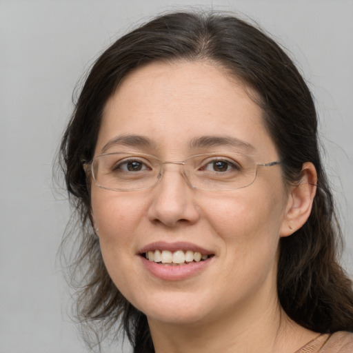 Joyful white adult female with long  brown hair and brown eyes