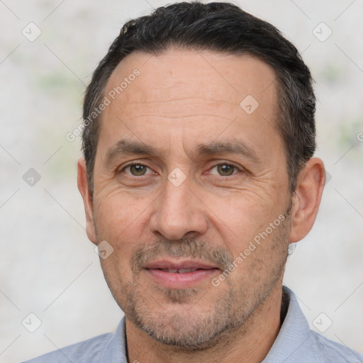 Joyful white adult male with short  black hair and brown eyes