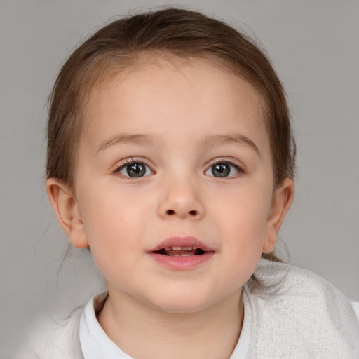 Joyful white child female with short  brown hair and brown eyes