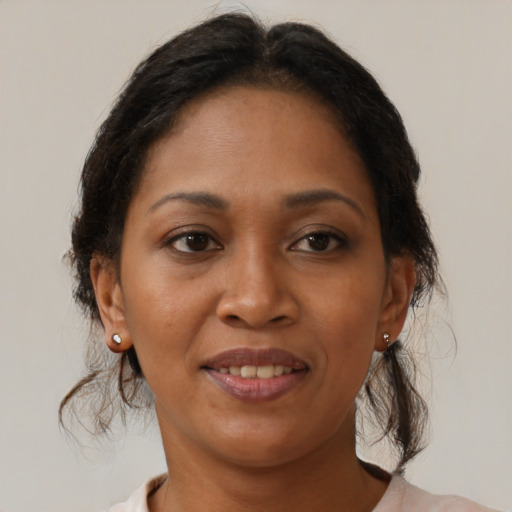 Joyful latino adult female with medium  brown hair and brown eyes