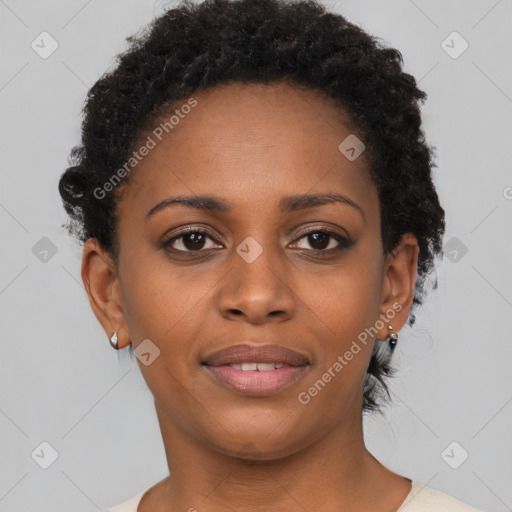 Joyful black young-adult female with short  brown hair and brown eyes