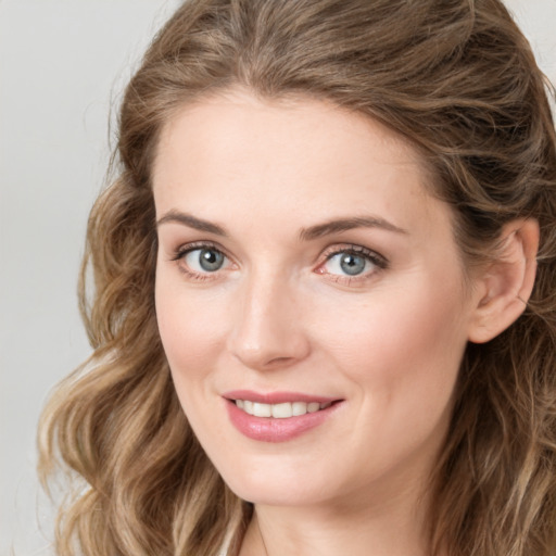 Joyful white young-adult female with long  brown hair and green eyes