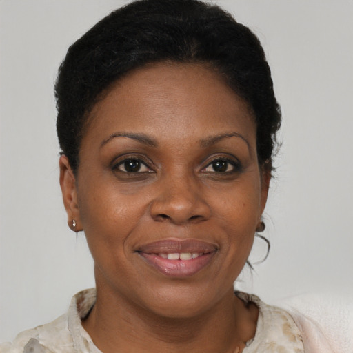 Joyful black young-adult female with short  brown hair and brown eyes