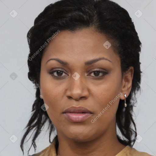 Joyful black young-adult female with long  brown hair and brown eyes