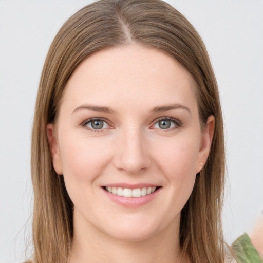 Joyful white young-adult female with long  brown hair and grey eyes