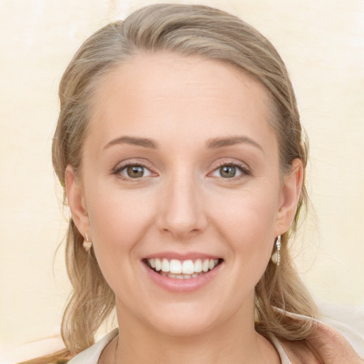 Joyful white young-adult female with medium  brown hair and blue eyes