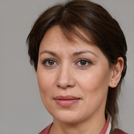 Joyful white adult female with medium  brown hair and grey eyes