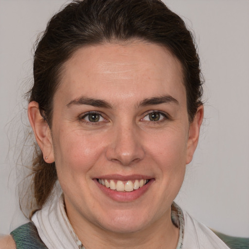 Joyful white adult female with medium  brown hair and brown eyes