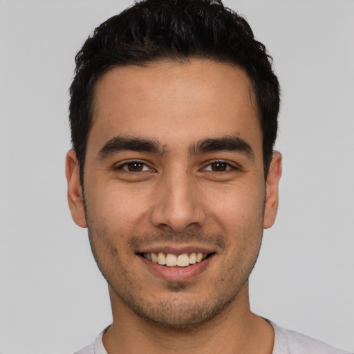 Joyful white young-adult male with short  black hair and brown eyes