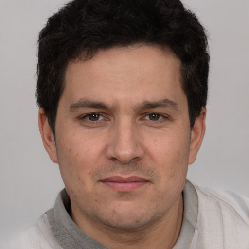 Joyful white adult male with short  brown hair and brown eyes