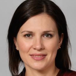 Joyful white adult female with medium  brown hair and grey eyes