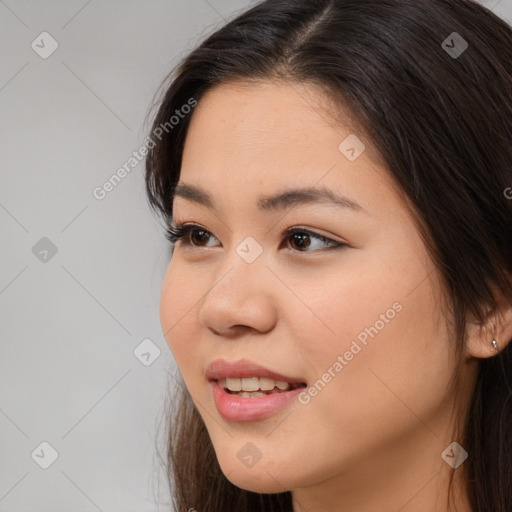 Joyful asian young-adult female with long  brown hair and brown eyes