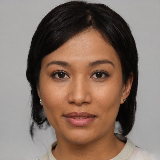 Joyful asian young-adult female with medium  black hair and brown eyes