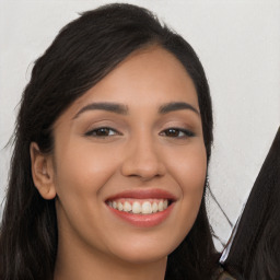 Joyful latino young-adult female with long  brown hair and brown eyes