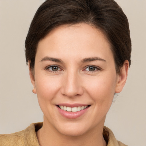 Joyful white young-adult female with short  brown hair and brown eyes