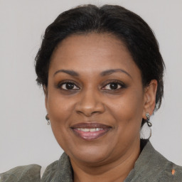 Joyful black adult female with medium  brown hair and brown eyes