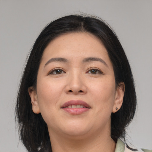 Joyful asian young-adult female with medium  brown hair and brown eyes