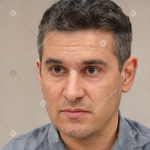 Joyful white adult male with short  black hair and brown eyes