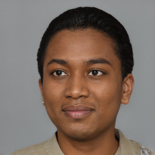 Joyful black young-adult male with short  black hair and brown eyes