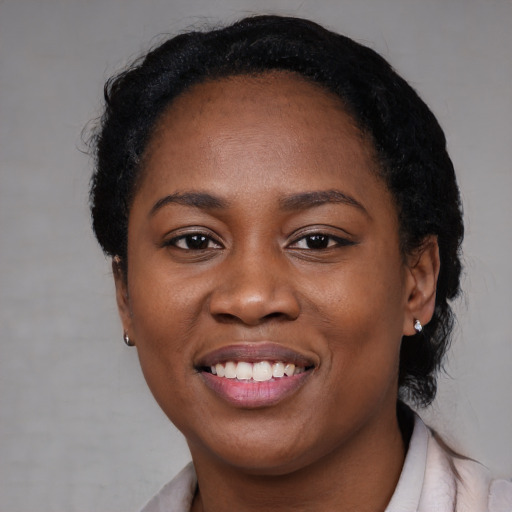 Joyful black young-adult female with medium  black hair and brown eyes