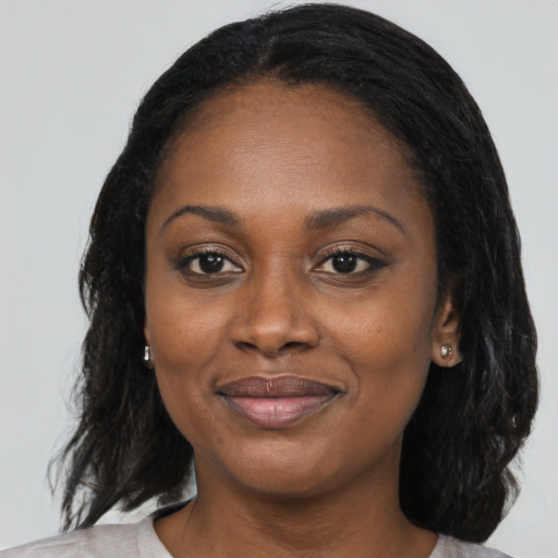 Joyful black young-adult female with medium  black hair and brown eyes